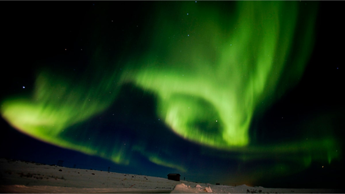 Aurora borealis, or northern lights, fill the sky over Finnmark county, northern Norway.