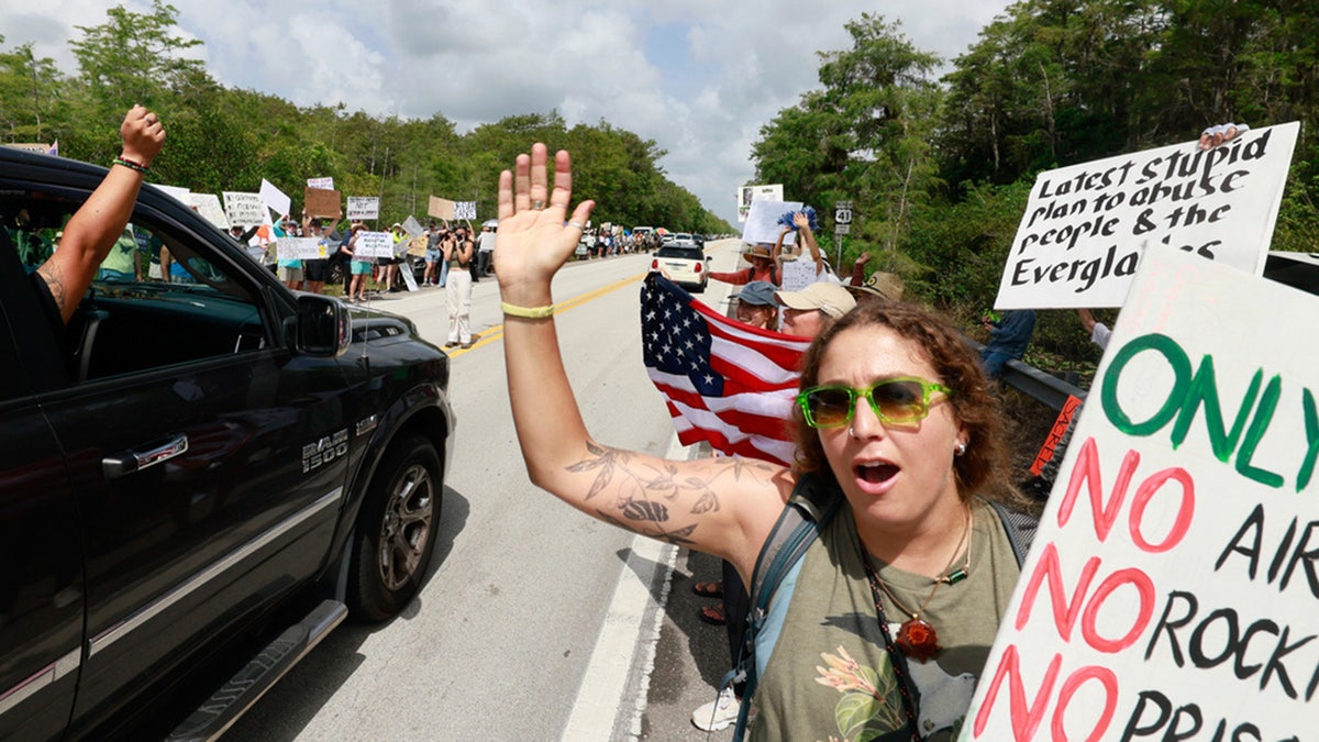 Environmental advocates protest against "Alligator Alcatraz" being built in Ochopee, Fla., on Saturday, June 28, 2025.