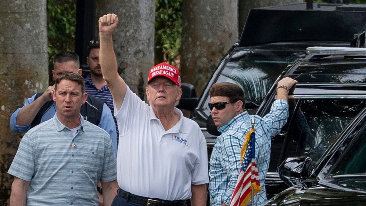 Trump waves to supporters