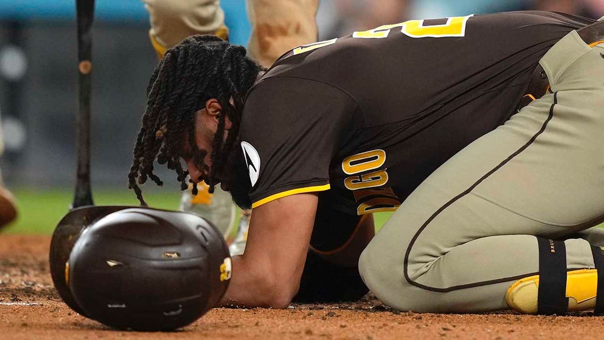 Fernando Tatis Jr. kneels in pain