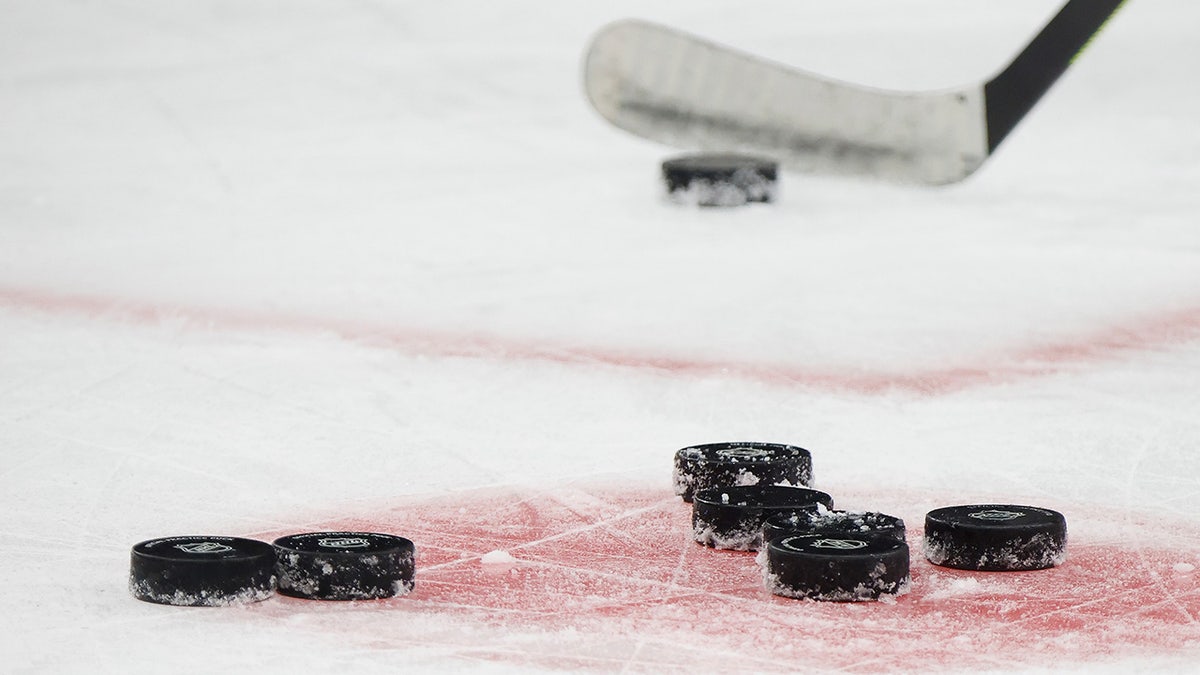 A hockey stick and pucks