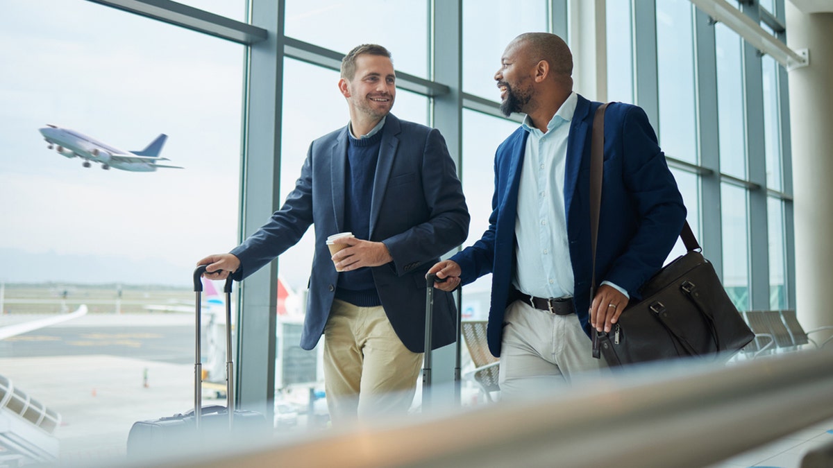 businessmen walking through airport