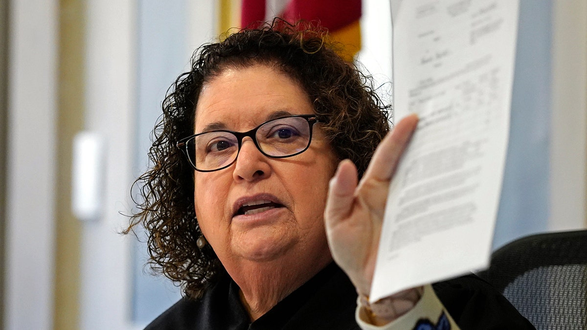 Hamilton County Common Pleas Judge Jennifer L. Branch on bench holding a document