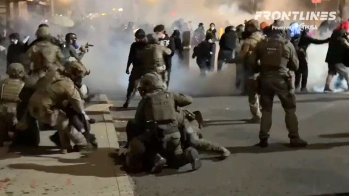 Federal agents and protesters clash outside an Immigration and Customs Enforcement facility in Portland, Oregon