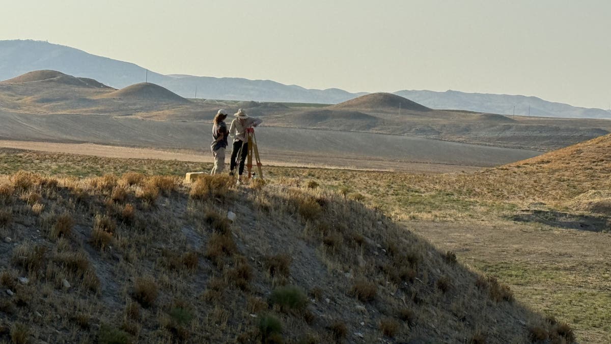 Archaeologists on top of burial mound