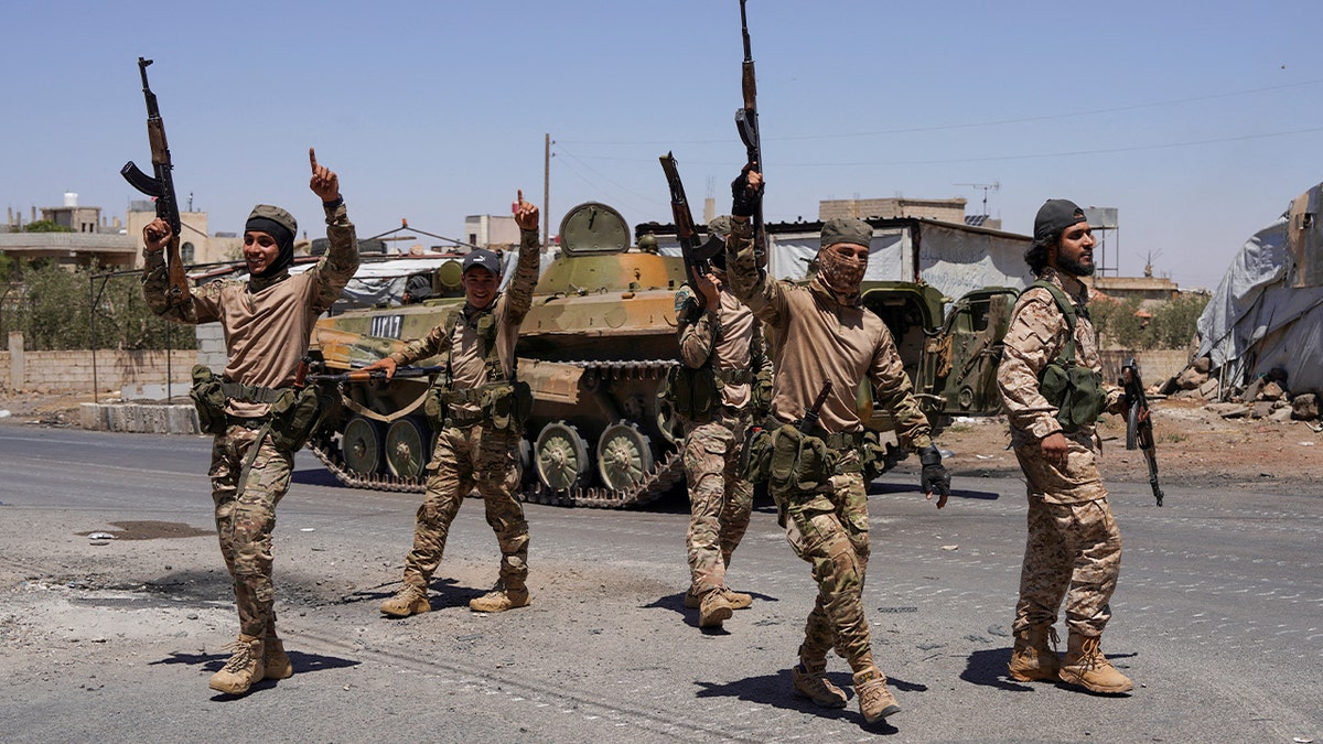 Syrian security forces with guns in air