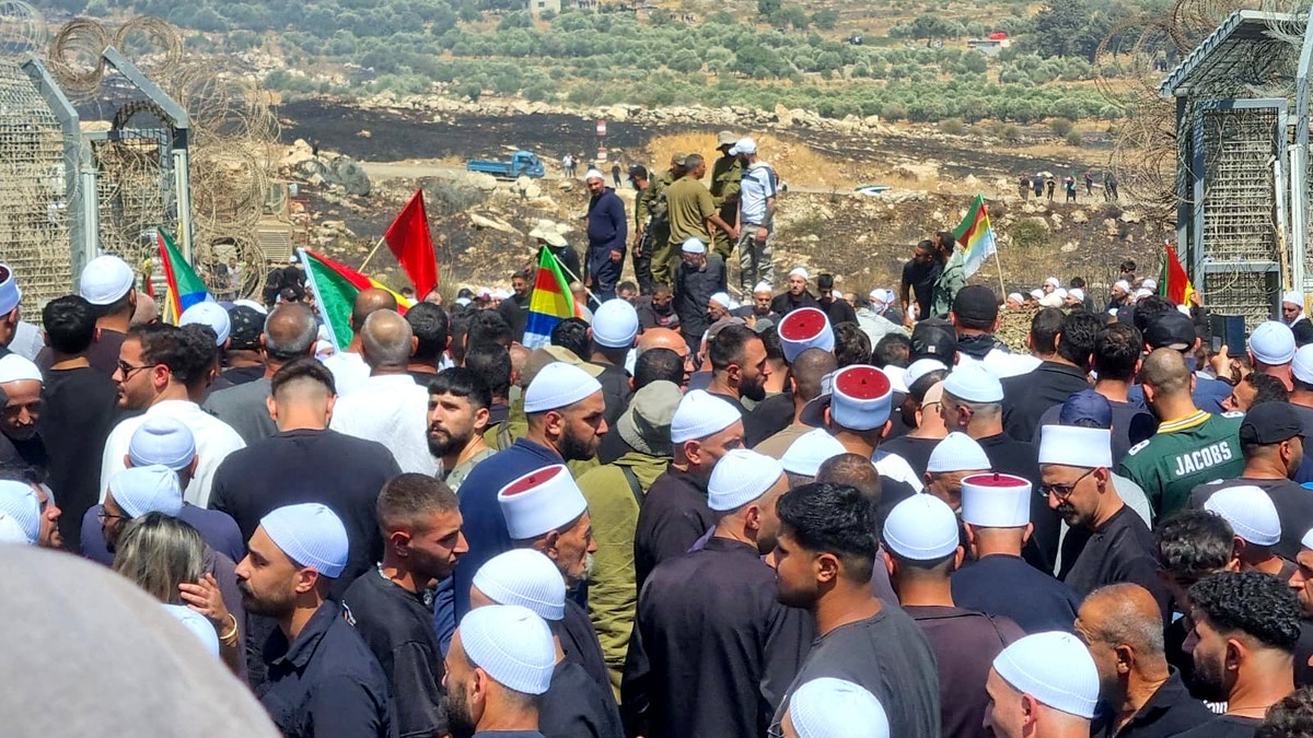 Israeli Druze in the Golan Heights mass along the Syrian border on July 16, 2025. Many breached the border in a bid to help their Syrian brethren, who have been locked in days of ethnic violence against Bedouins and the Syrian army.