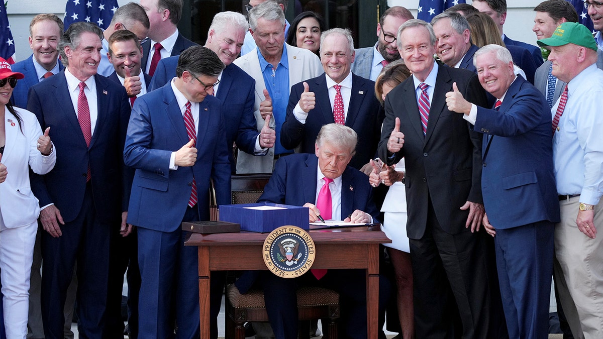 Trump signs the Big Beautiful Bill, surrounded by legislators