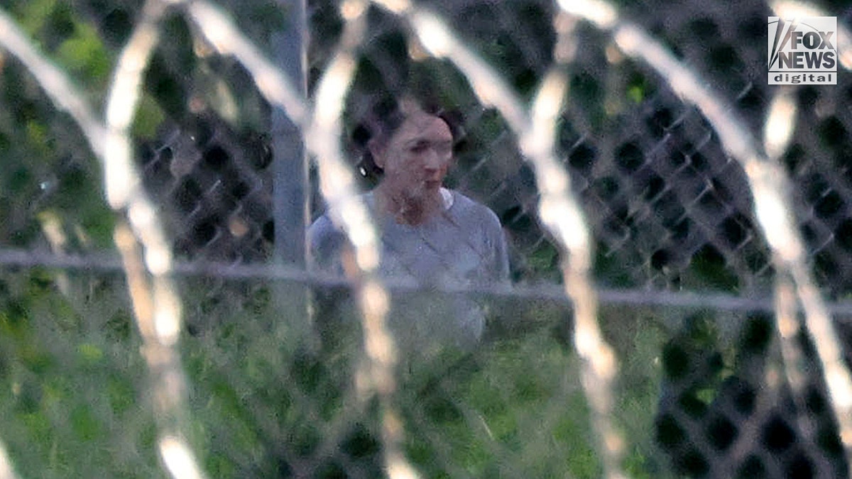 Ghislaine Maxwell behind razor wire