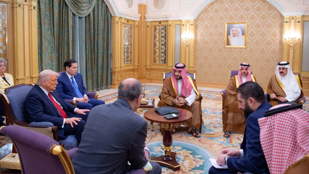 Syrian President Ahmed al-Sharaa meets with President Donald Trump and Saudi Crown Prince Mohammed Bin Salman and other officials in Riyadh, Saudi Arabia, in this handout released on May 14, 2025.