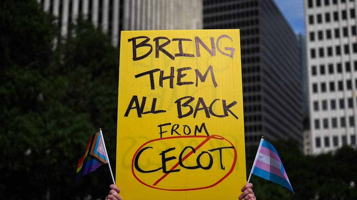 A person holds up a sign referencing the Centre for Terrorism Confinement (CECOT) prison in El Salvador during a May Day demonstration against US President Donald Trump and his immigration policies in Houston, Texas, on May 1, 2025. (Photo by RONALDO SCHEMIDT / AFP)