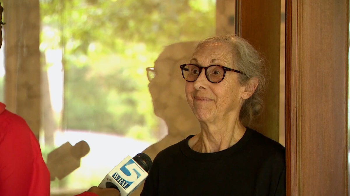 A woman speaks to a reporter a wing flap that fell off of a Boeing 737-900 was found in a North Carolina driveway.