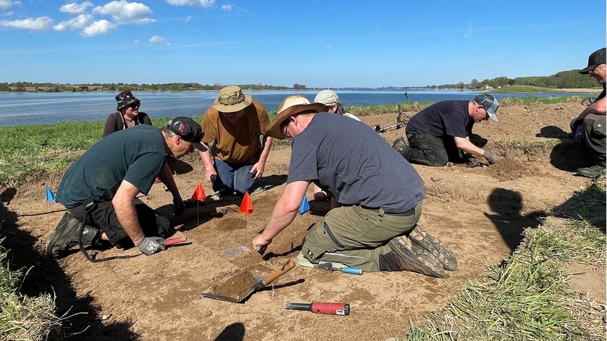 Volunteers working on bank of river