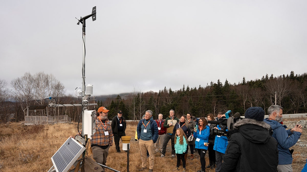 Weather station on Mount Washington with visitors during fall season