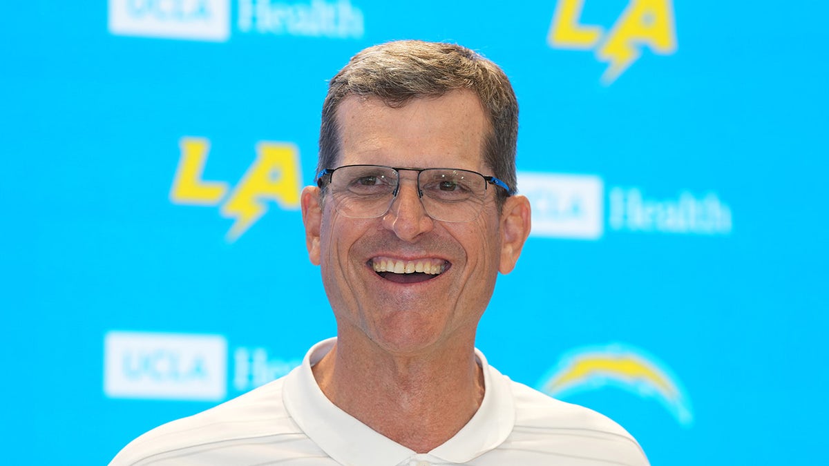 Jim Harbaugh smiling during press conference