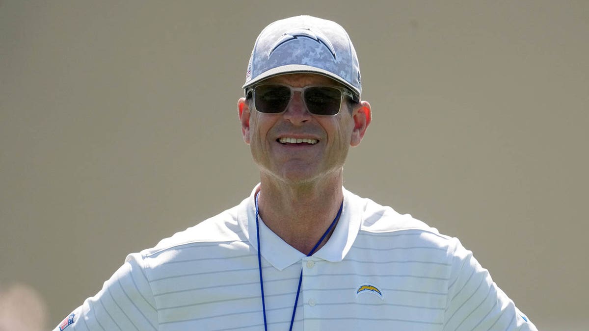 Jim Harbaugh looks on