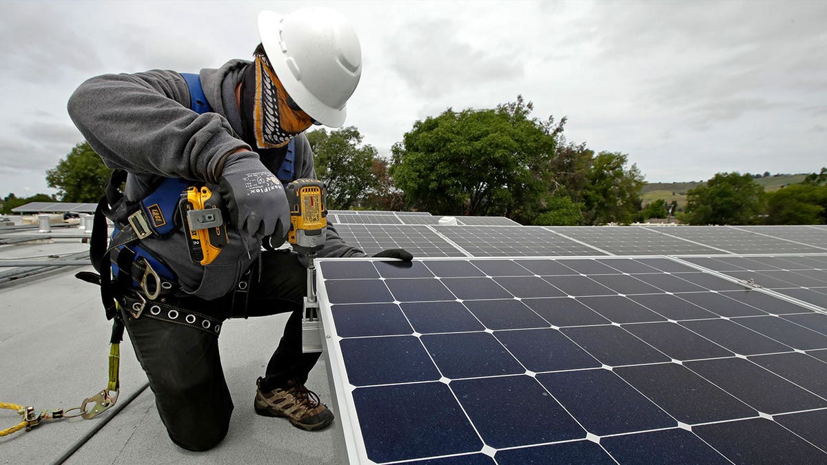 man installing solar panels