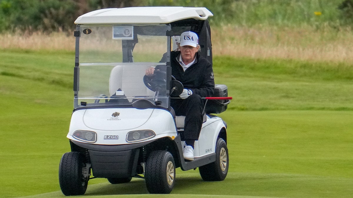 Trump driving a golf cart 