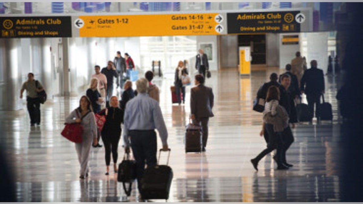 Passengers move through a JFK airport terminal.