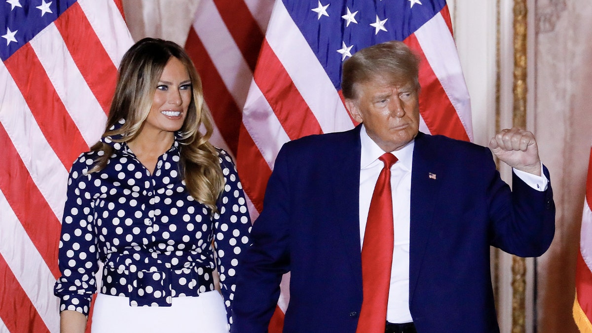 President Donald Trump and first lady Melania Trump stand together during an event at his Mar-a-Lago home.