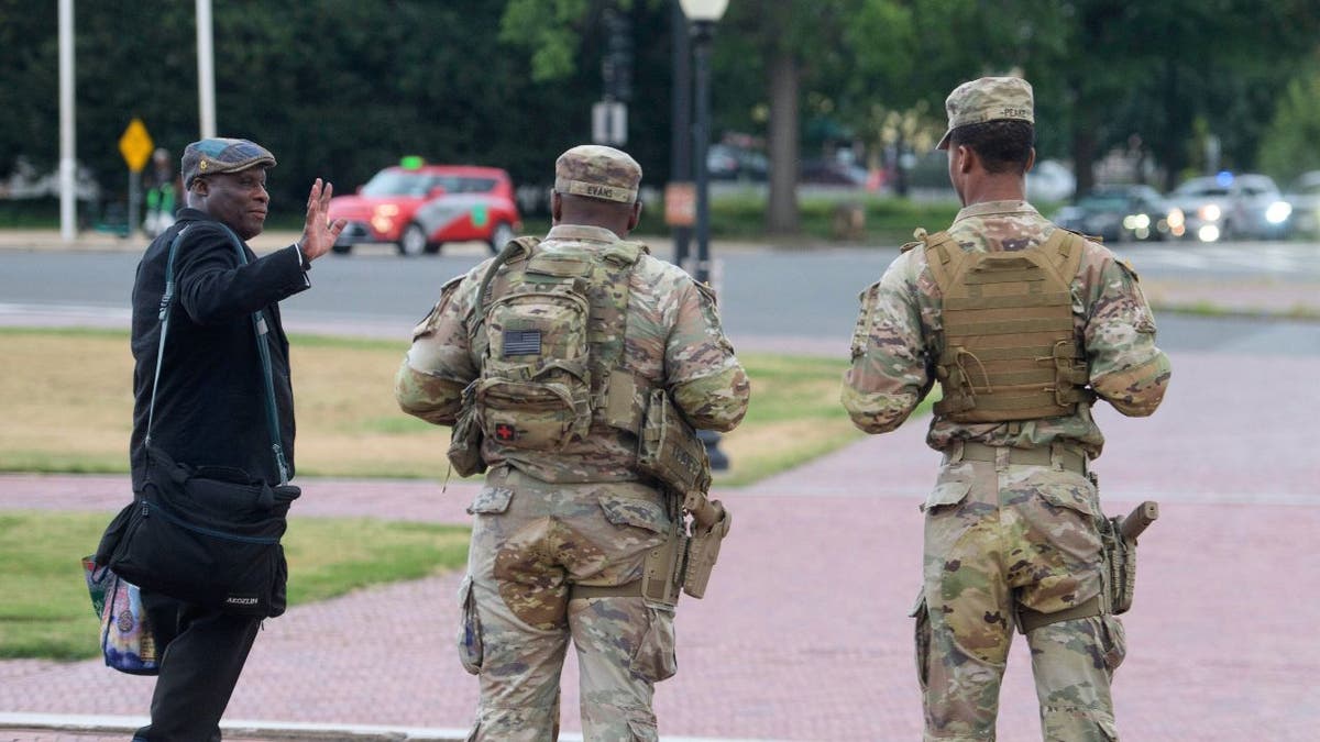 Two armed National Guard soldiers stand outside Union Station in Washington, D.C., Aug. 24, 2025.