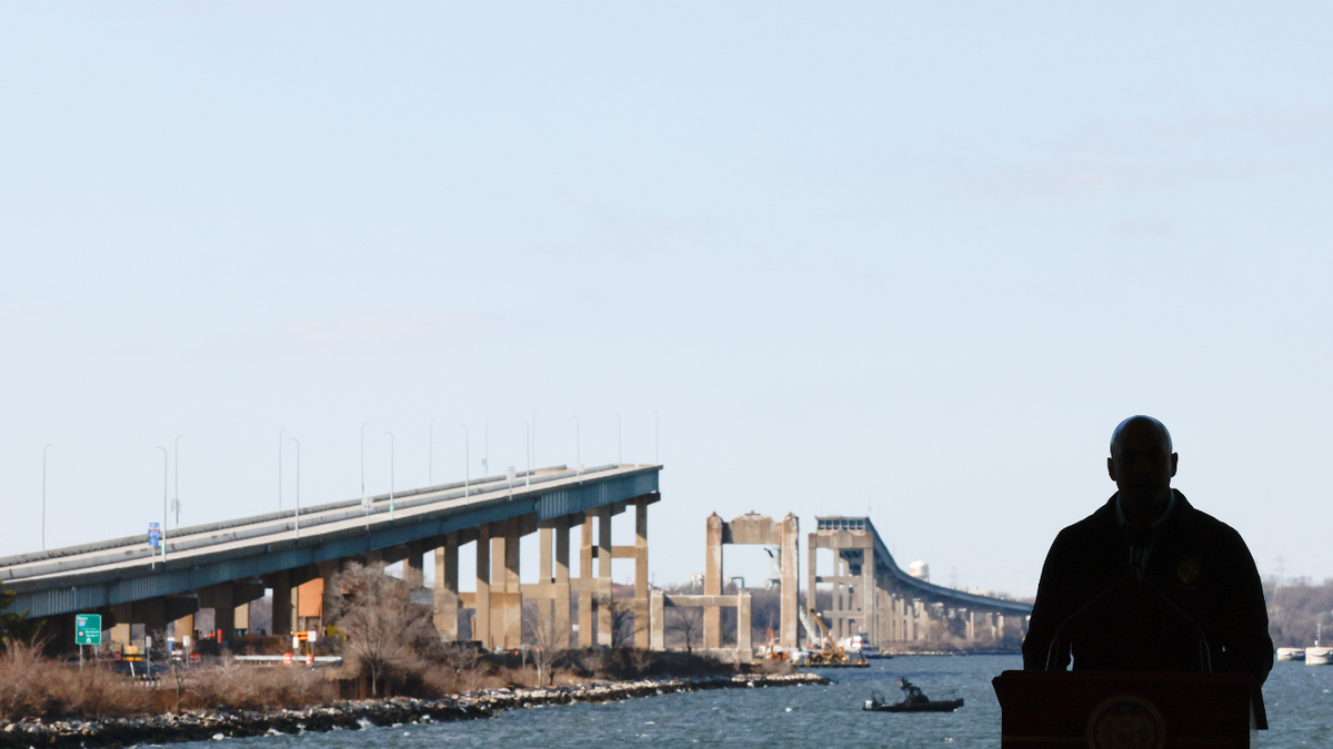 Maryland Governor Wes Moore in silhouette with a view of the Francis Scott Key Bridge
