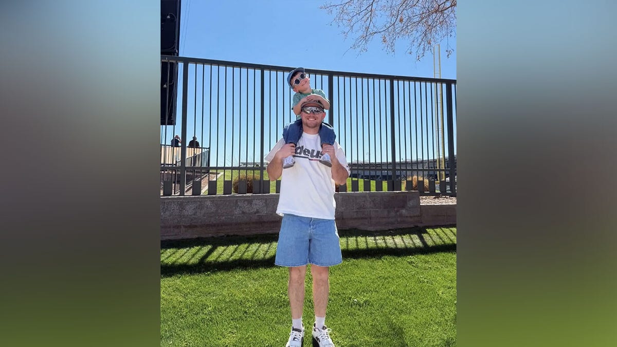 Trigg Kiser on Brady Kiser's shoulders outside