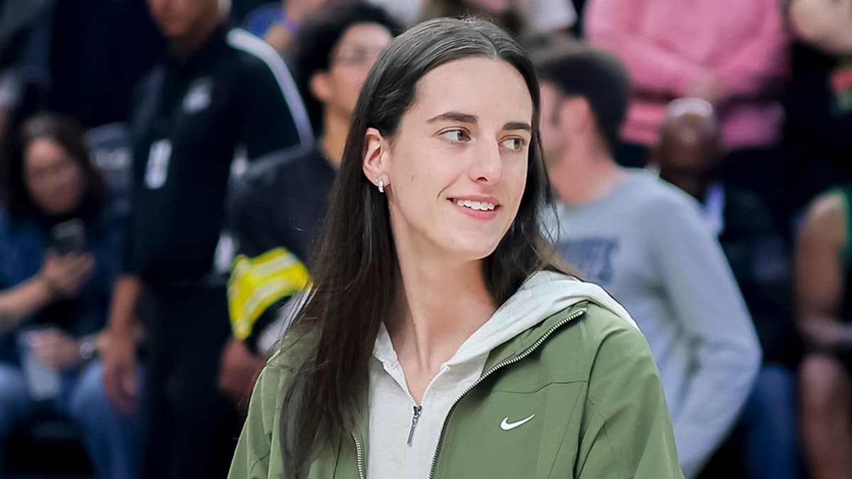 Caitlin Clark looks on court smiling