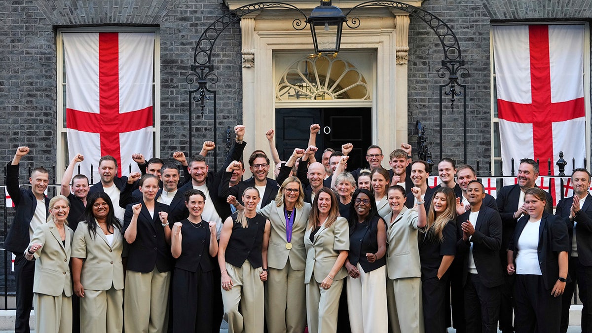 England women's head football coach Sarina Wiegman, center, poses with her staff and England's Football Association president Debbie Hewitt, 2nd left, after leaving a special reception, to celebrate their victory in the Women's Euro 2025 final, at Downing Street in London, Monday, July 28, 2035.