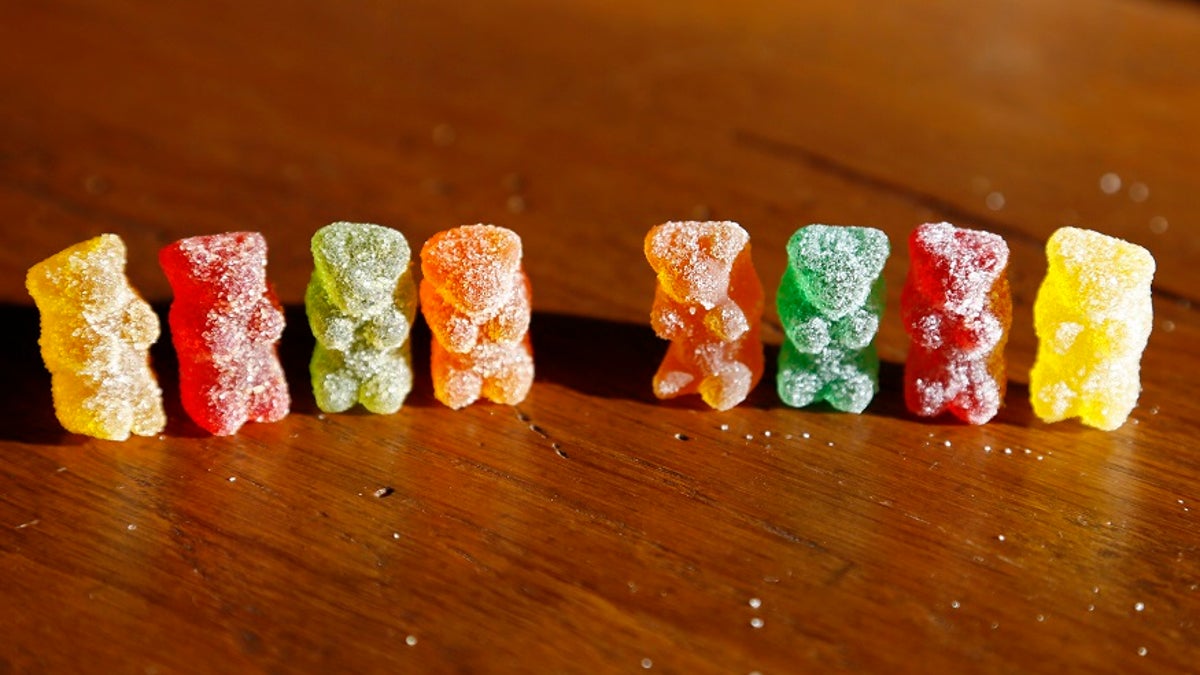 Marijuana-infused sour gummy bear candies (L) are shown next to regular ones at right in a photo illustration in Golden, Colorado October 17, 2014.