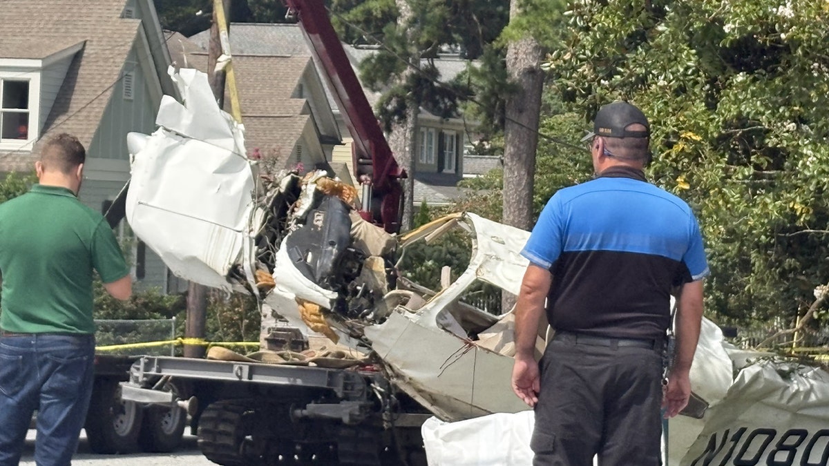 plane wreckage being towed