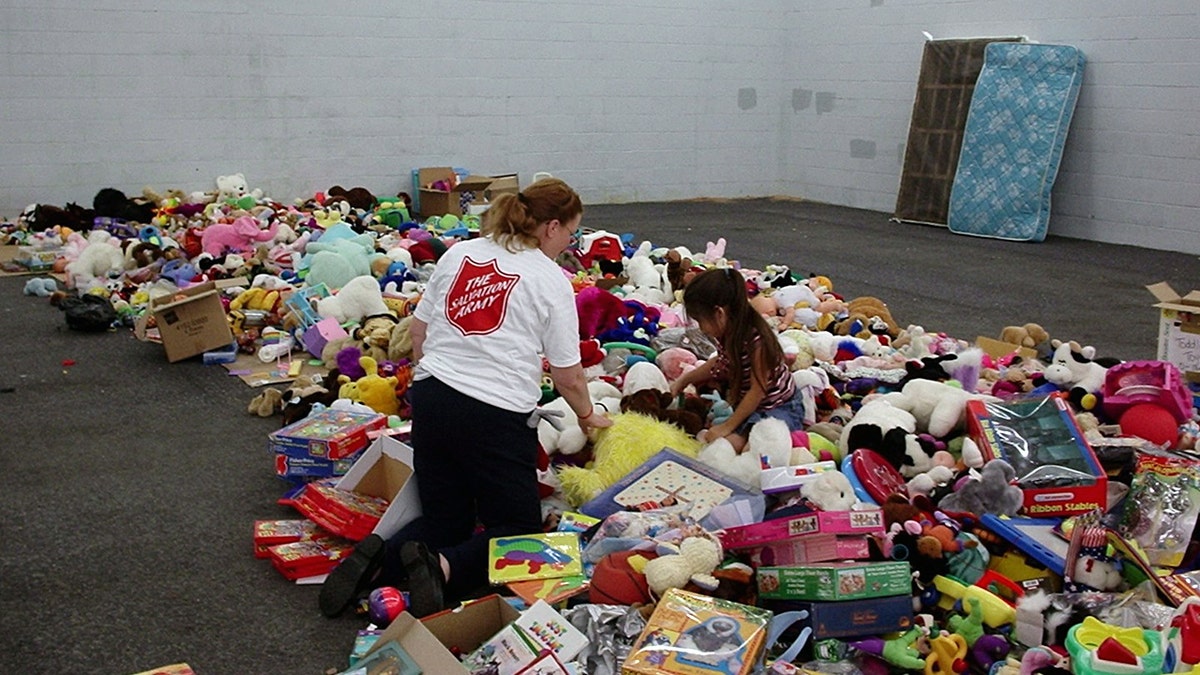 A woman and a girl in a pile of toys