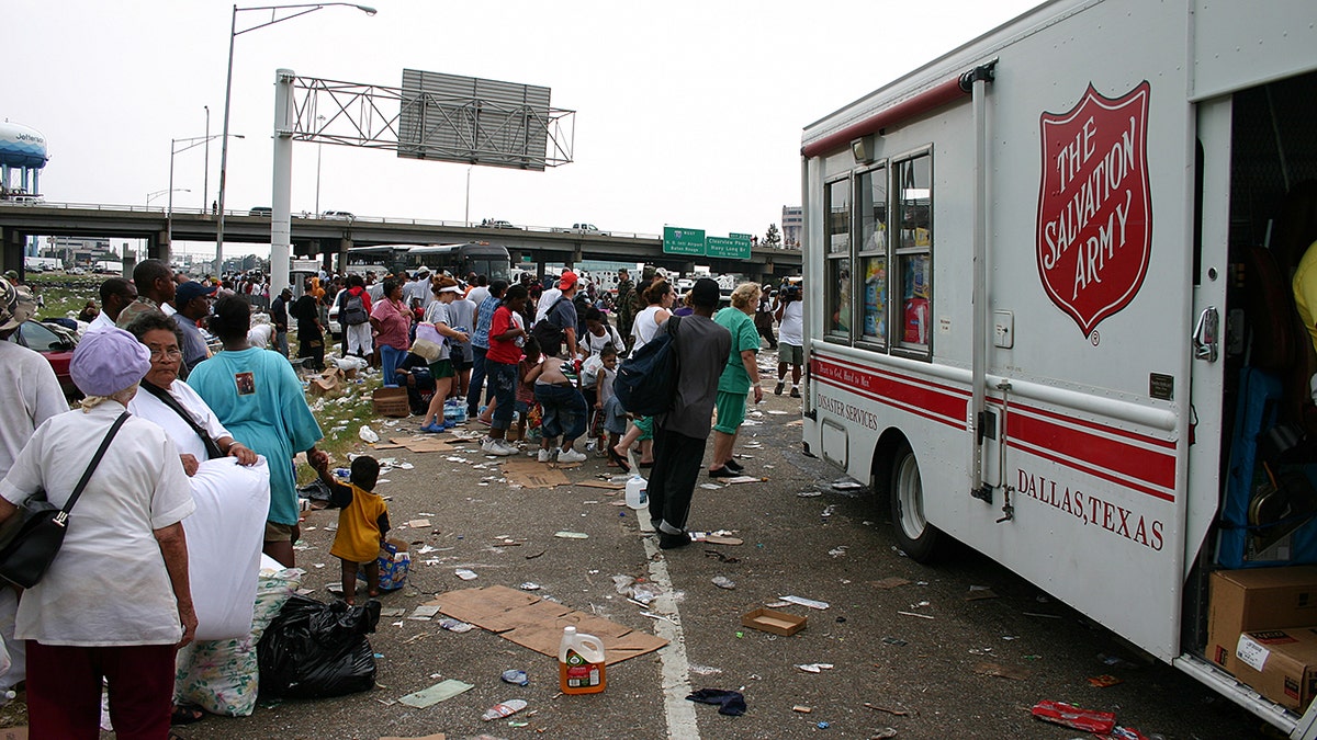 People in the street with debris on the ground