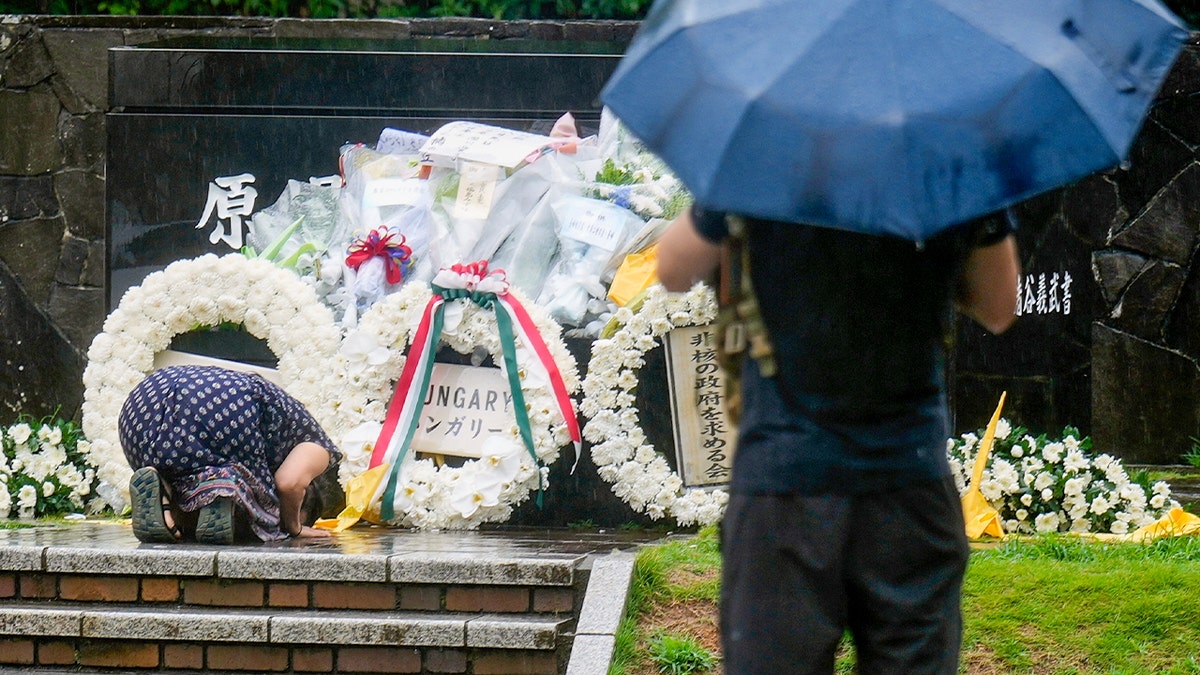 Woman prays at ceremony honoring victims of Nagasaki bombing