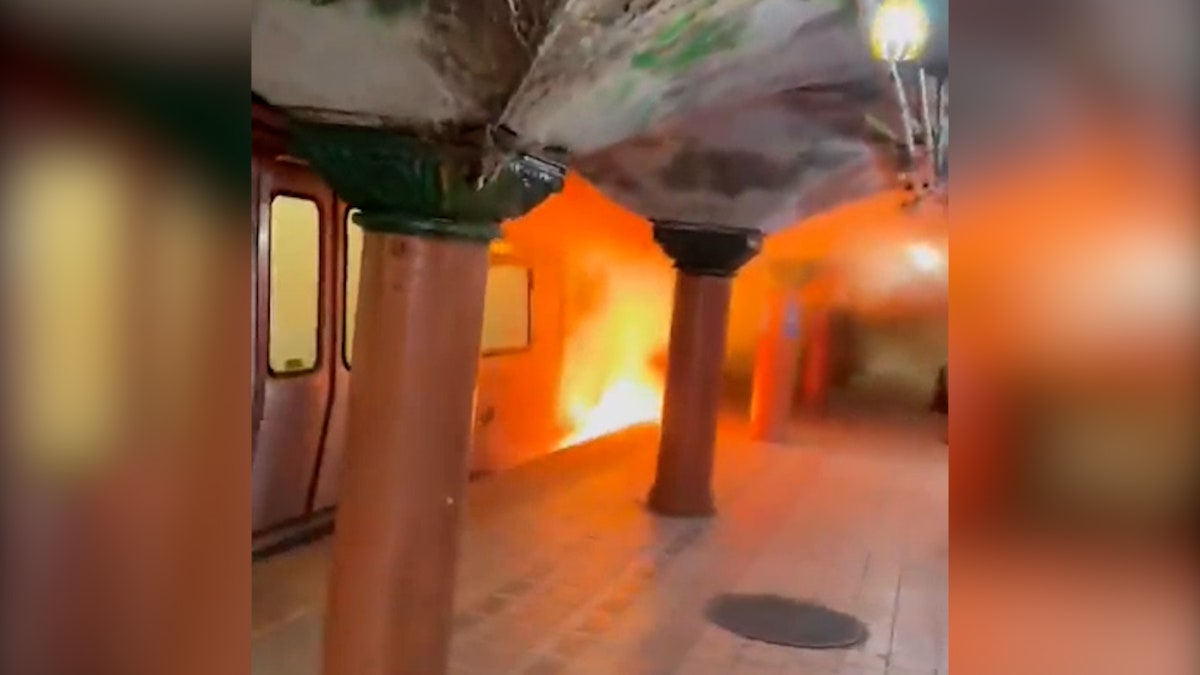 fire emerges from base of subway car