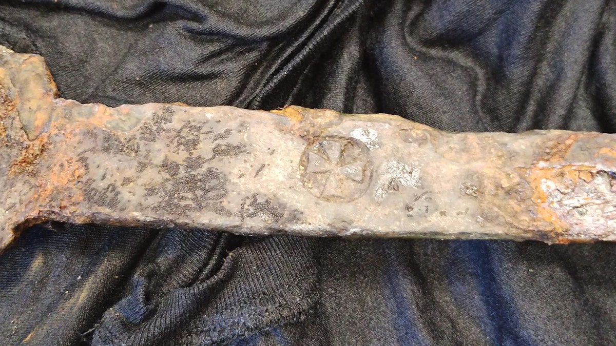 Close-up of distinct mark on sword