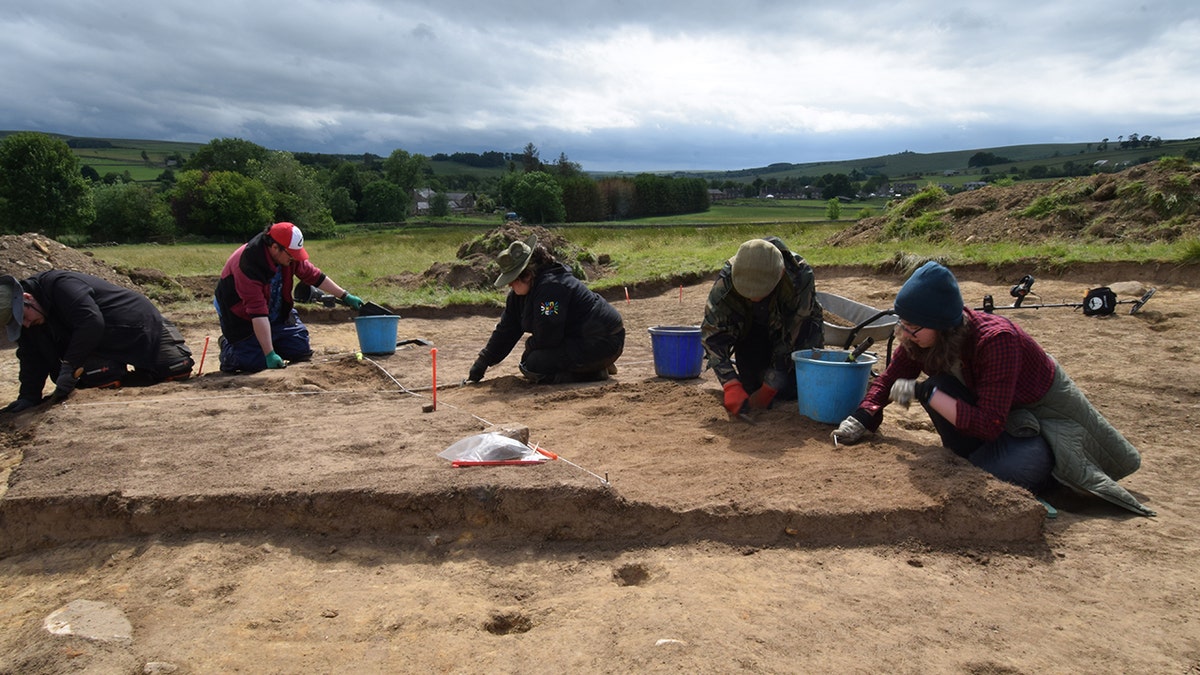 Students digging at excavation site