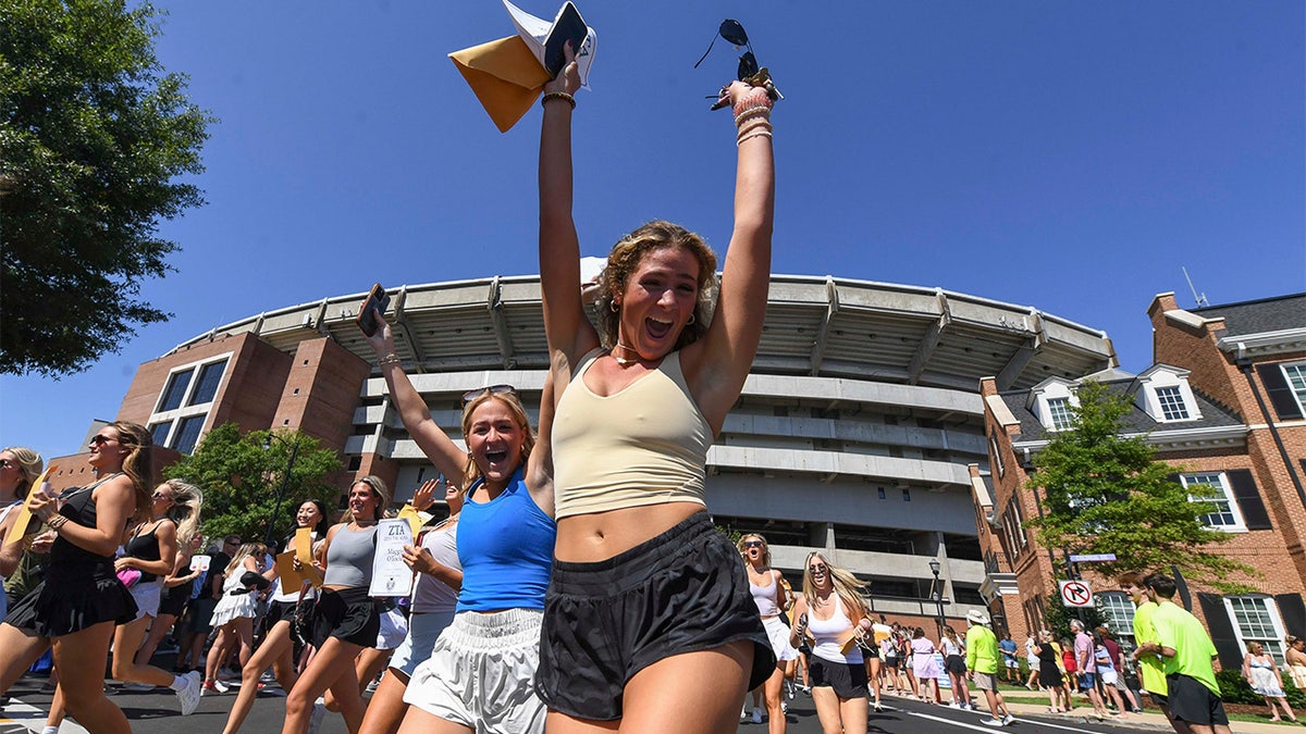 College students cheer after being chosen for their sorority at the University of Alabama