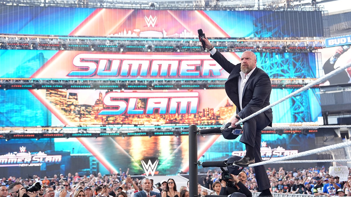 Triple H celebrates with the crwod