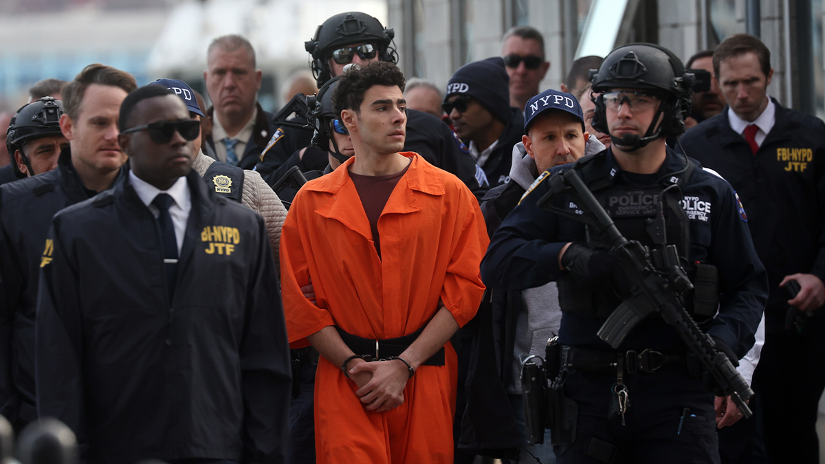 Luigi Mangione, suspect in the killing of UnitedHealthcare CEO Brian Thompson in New York City, arrives at a heliport with members of the NYPD on December 19, 2024 in New York City. The 26-year-old was arrested in Pennsylvania on December 9 after being spotted at a McDonald's in Altoona amid a national manhunt. Mangione also appeared in a Pennsylvania court on forgery and firearms charges today, where he waived extradition to New York after being indicted on 11 charges including first-degree murder in furtherance of terrorism. 