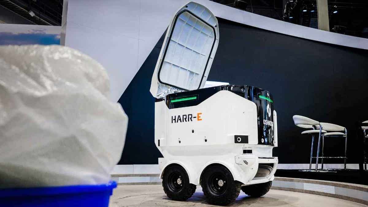 white cube-like robot on wheels opens up lid