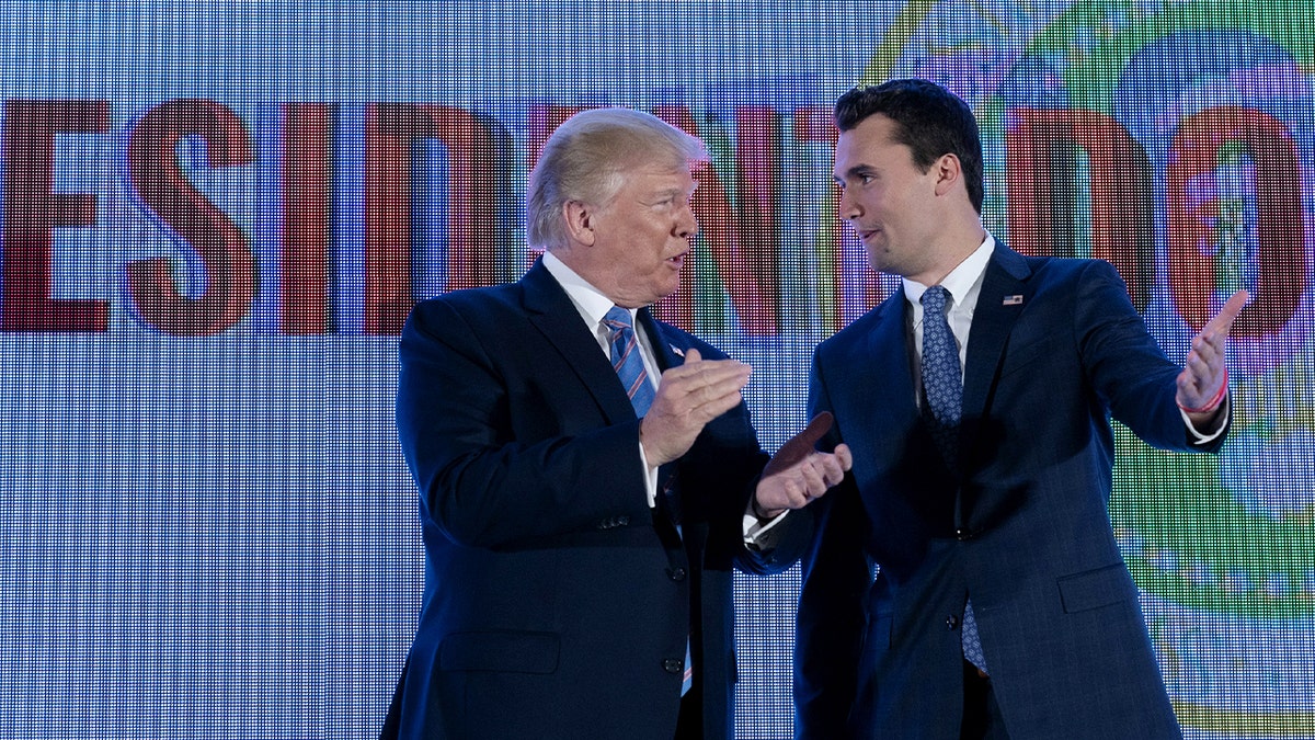 charlie kirk and donald trump durign rally smiling