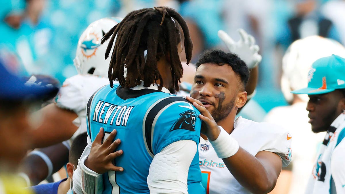 Cam Newton and Tua Tagovailoa interact