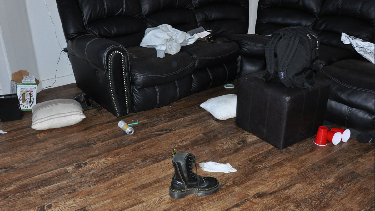 Red cups, empty cans, clothing and a pair of boots scattered across the living room inside the Idaho student murders crime scene.