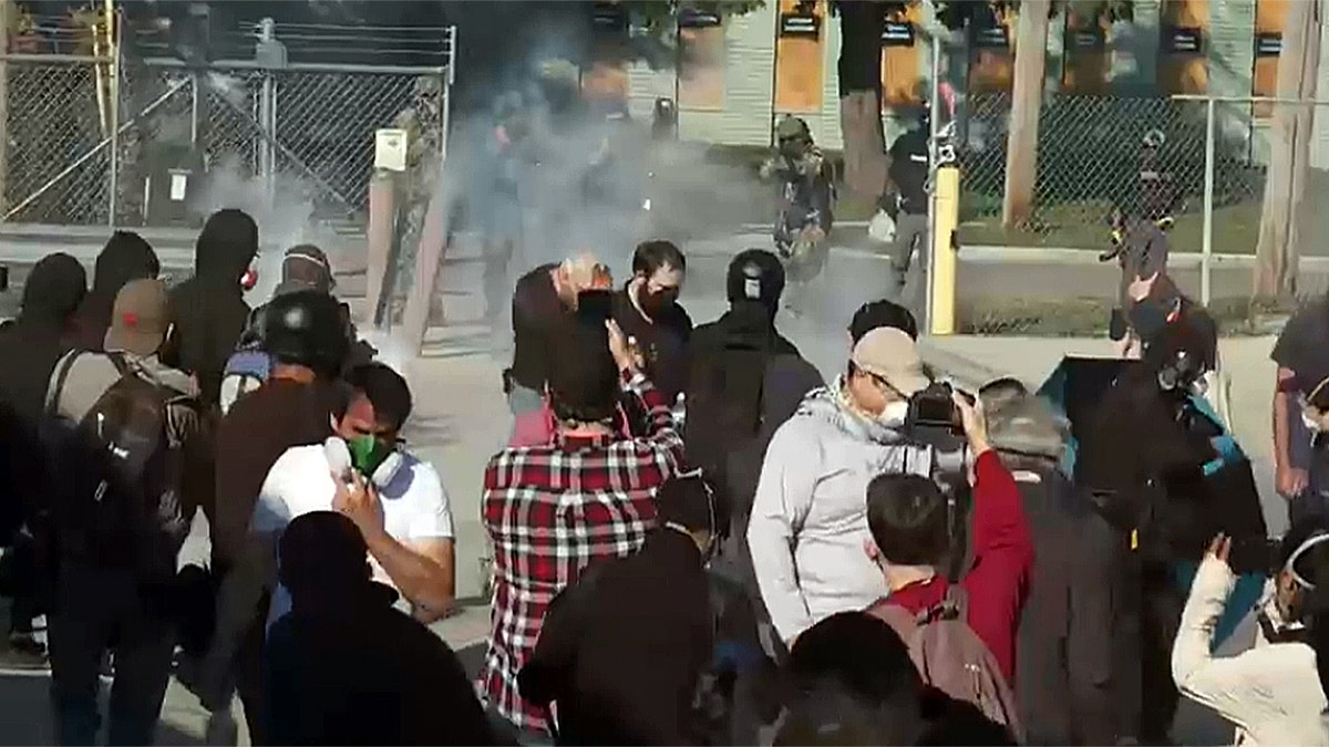 Smoke rises during anti-ICE protest outside of Chicago