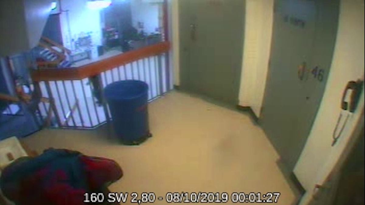 A still image from surveillance video shows a trash can, railing and heavy steel doors in a portion of the wing where Jeffrey Epstein was held when he died