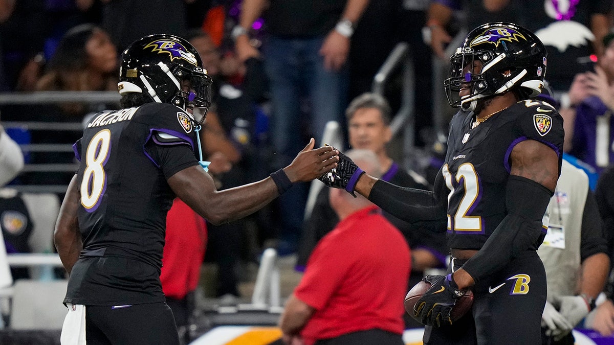Lamar Jackson and Derrick Henry clasp hands