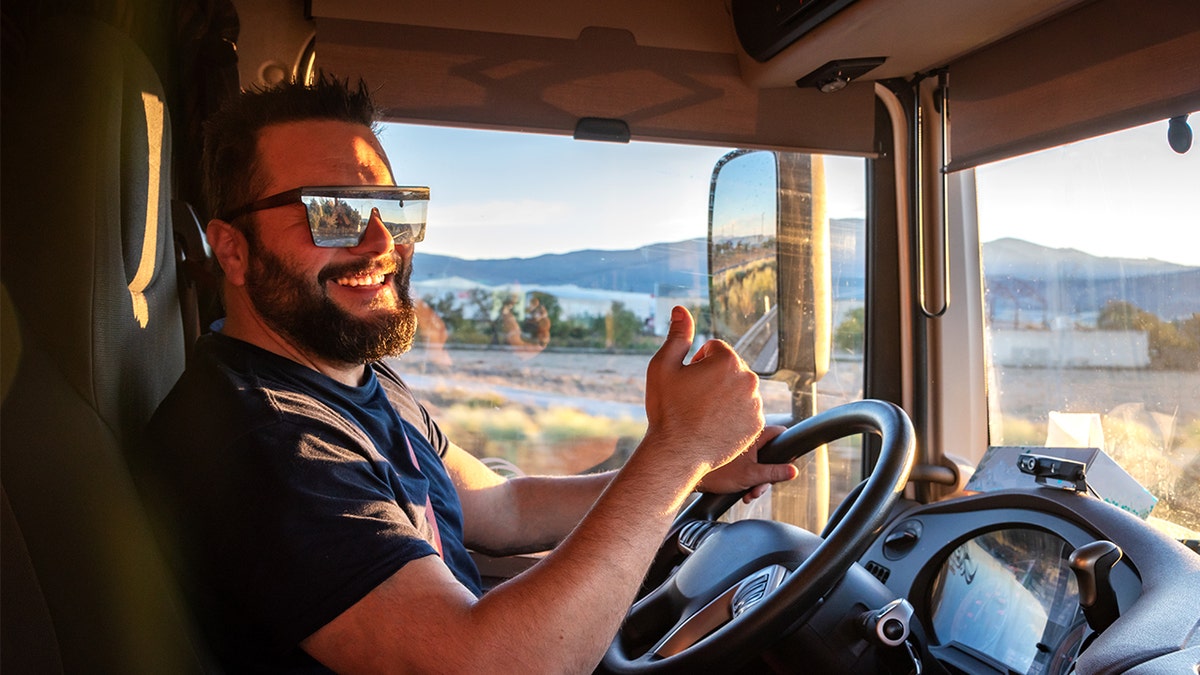 Happy truck driver giving thumbs up