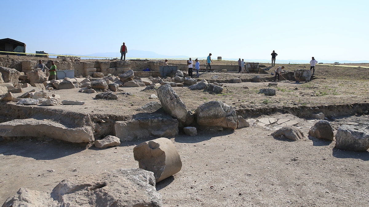 Excavators walking among ruins of Laodicea site