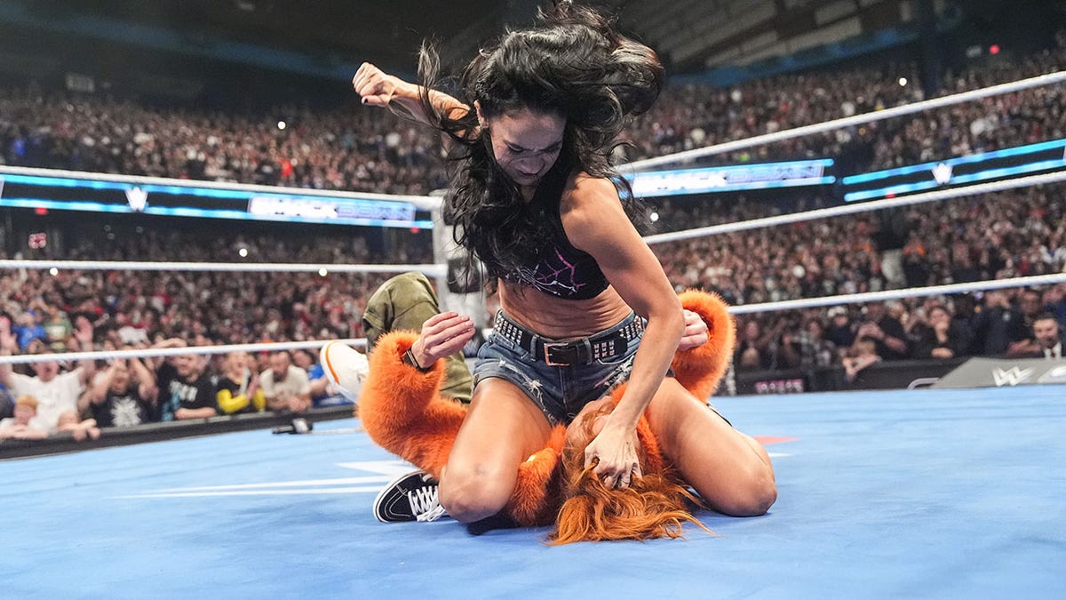 AJ Lee beats down Becky Lynch